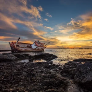 Boat wreck lying in sunset