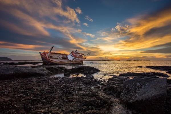 Boat wreck lying in sunset